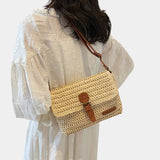 Beige knit small shoulder bag worn crossbody, front flap with brown tab and pocket