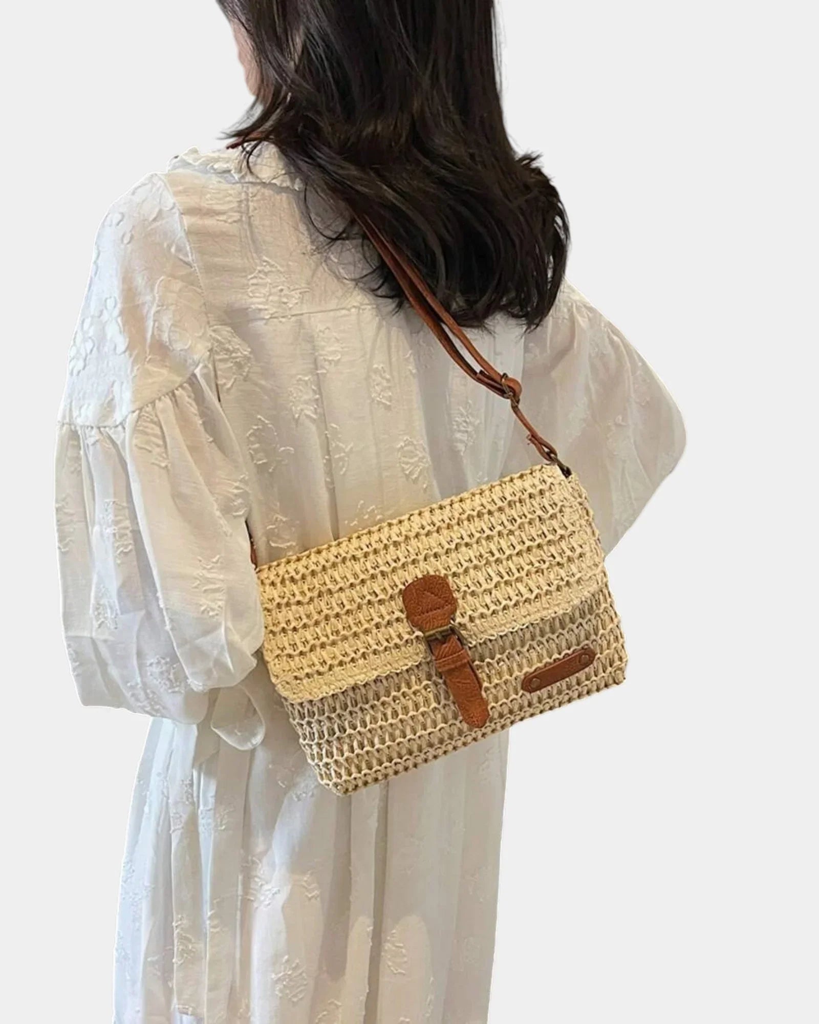 Beige knit small shoulder bag worn crossbody, front flap with brown tab and pocket