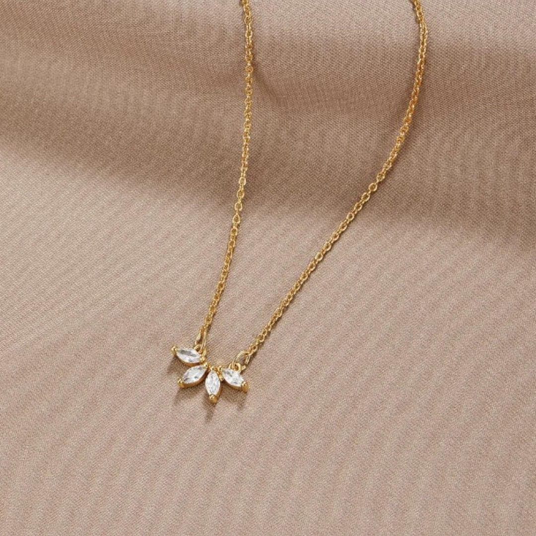 Gold-tone chain necklace with sparkling leaf-shaped crystal pendant cluster