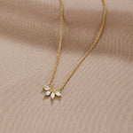 Gold-tone chain necklace with sparkling leaf-shaped crystal pendant cluster