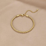 Gold braided chain bracelet with clasp and short extender loop