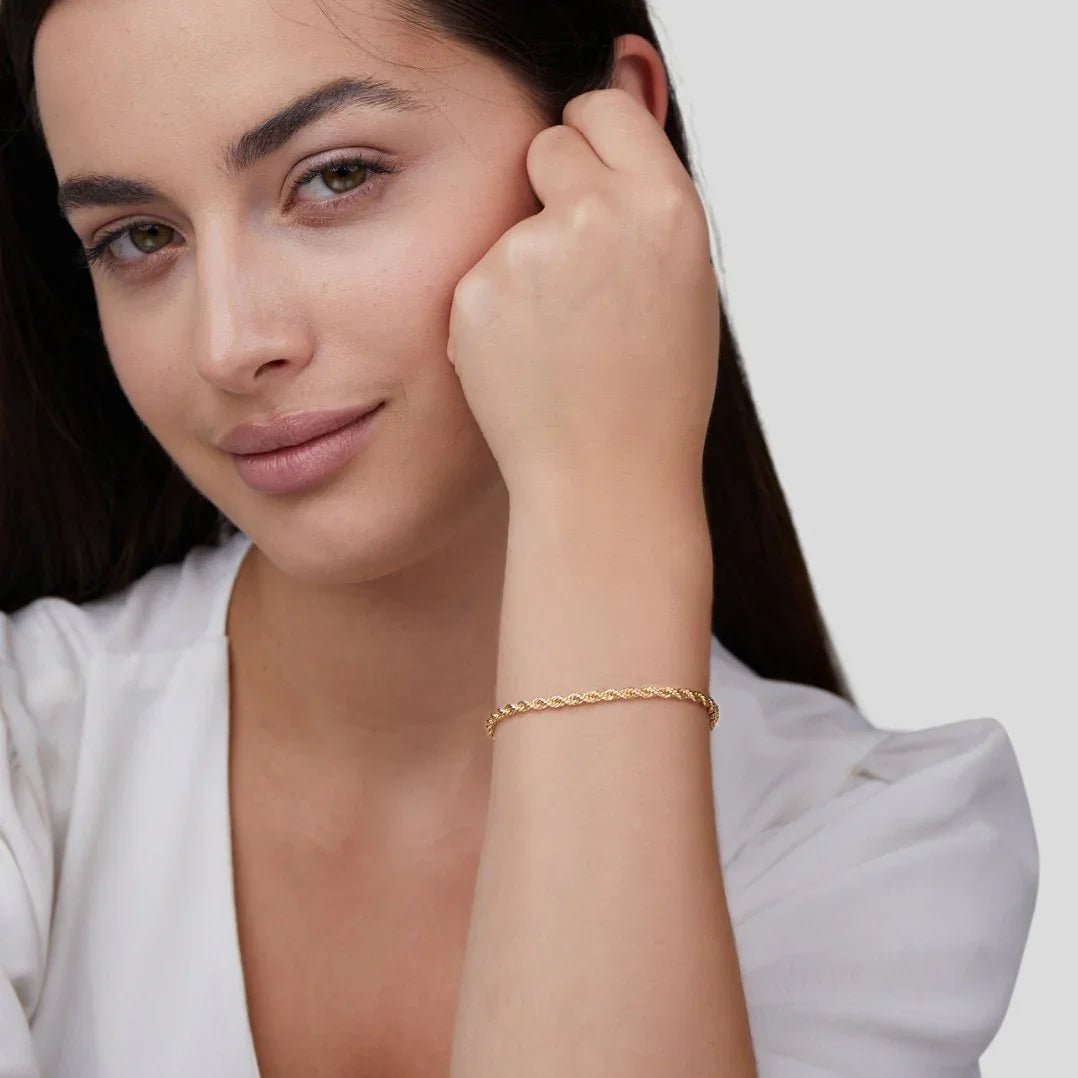 Gold chain bracelet worn on wrist, small clasp detail at side