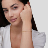 Gold chain bracelet worn on wrist, small clasp detail at side