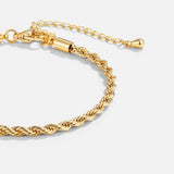 Gold chain bracelet with braided links and bar-like clasp extension
