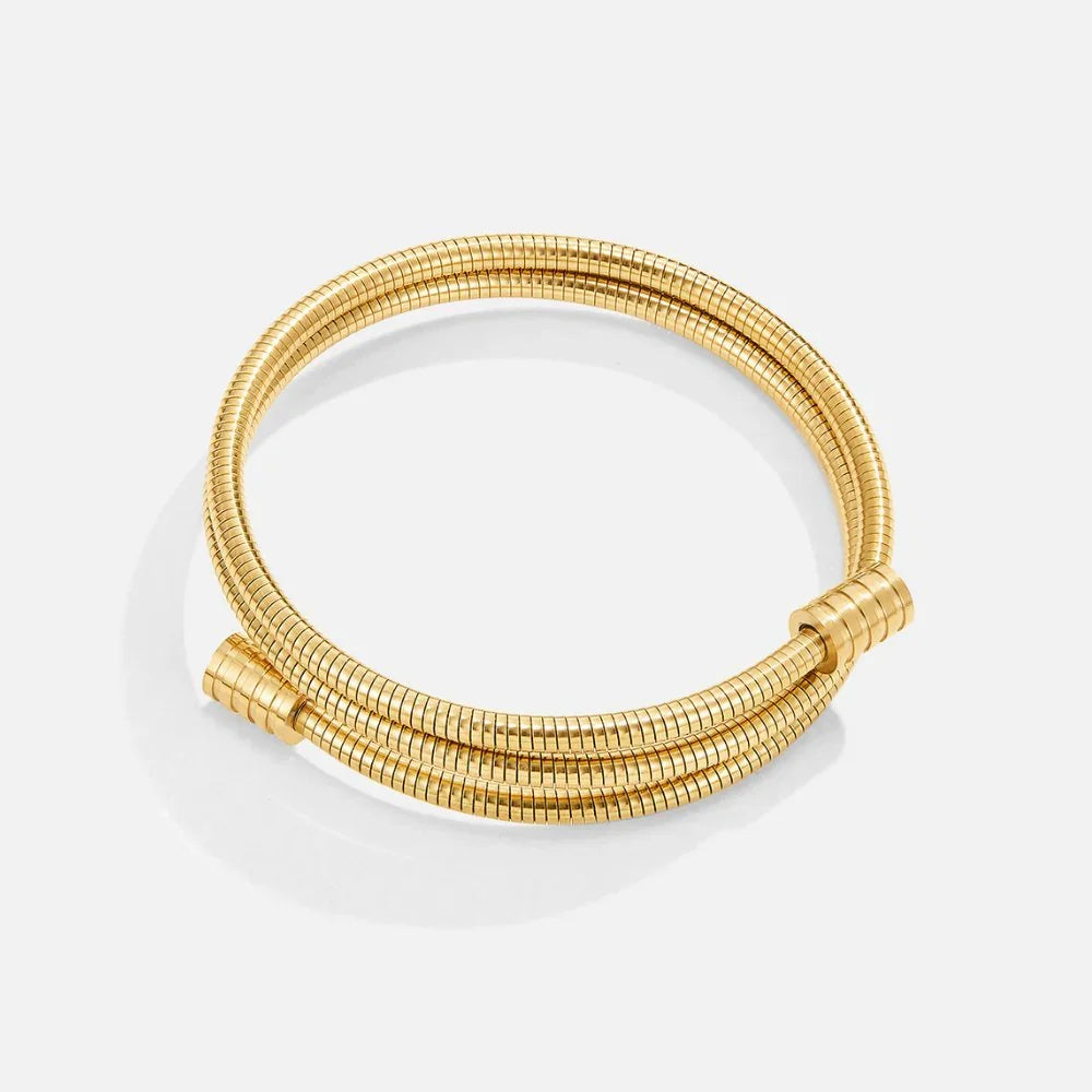 Gold coiled multi-strand bracelet with ribbed texture and rounded clasp