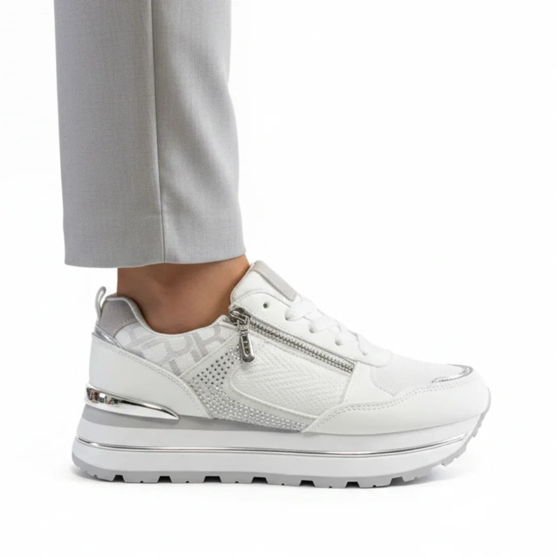 White women's sneakers with lace-up front, silver side zipper, chunky tread