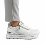 White women's sneakers with lace-up front, silver side zipper, chunky tread