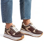 Brown and beige women’s comfort sneakers with white laces, zip closure, and tread sole