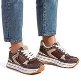 Brown and beige women’s comfort sneakers with white laces, zip closure, and tread sole
