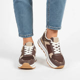 Brown women’s comfort sneakers with white laces, side zip detail, and cushioned sole