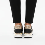 Black women's sneakers with metallic gold heel and white midsole