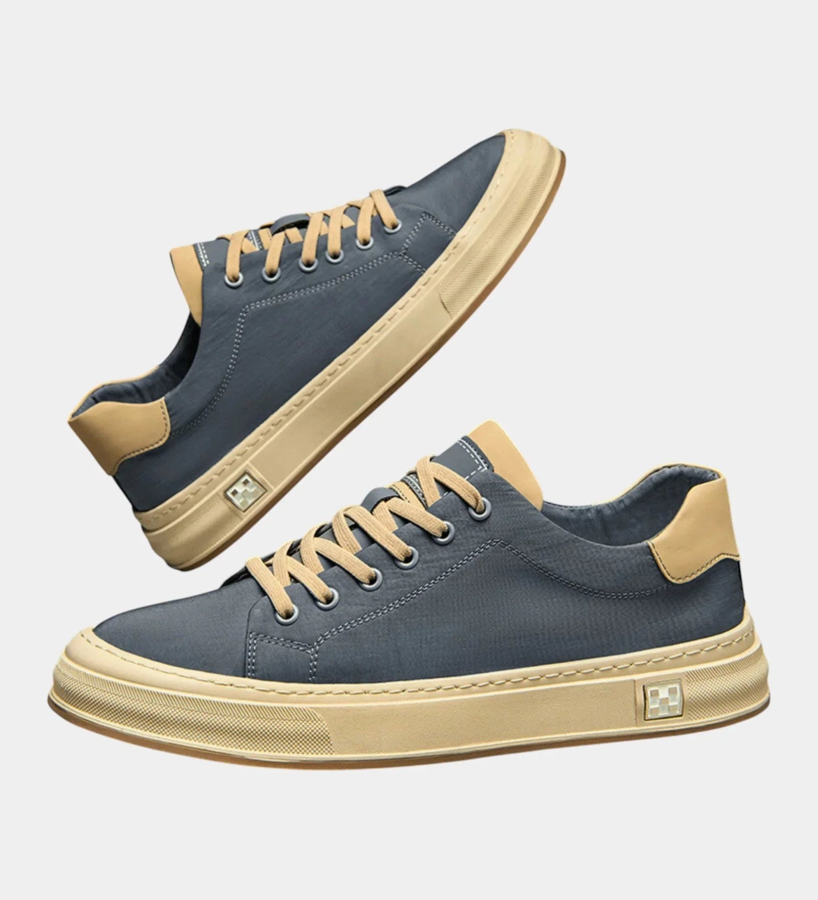 Low-top lace-up sneakers with blue upper, tan rubber sole, side logo patch