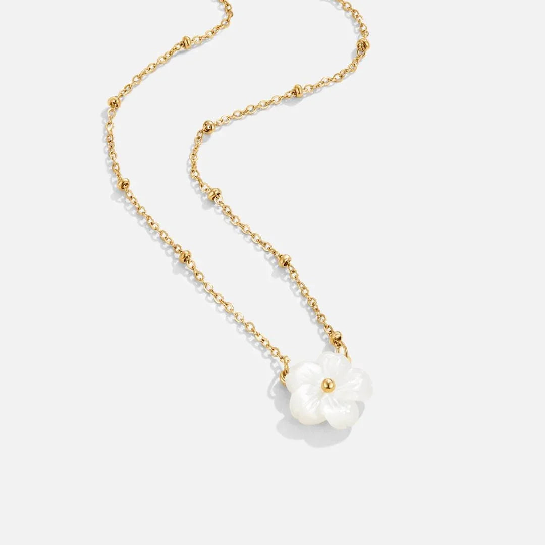Gold layered necklace with two white flower pendants on linked chain