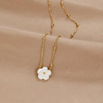Gold flower pendant necklace with white three-petal bloom on fine chain
