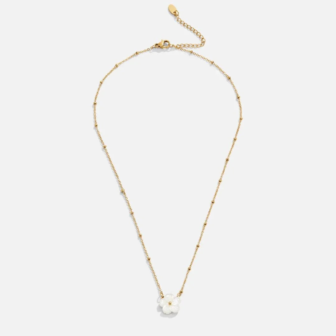 Gold flower pendant necklace with white bloom charm and extended chain
